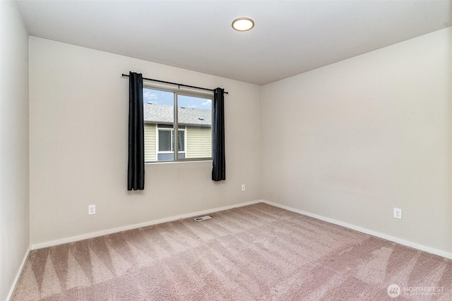 empty room with carpet floors and baseboards