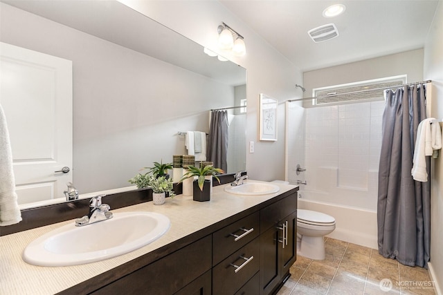 full bathroom featuring shower / tub combo, double vanity, and toilet