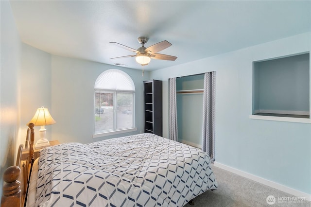 carpeted bedroom featuring baseboards and ceiling fan