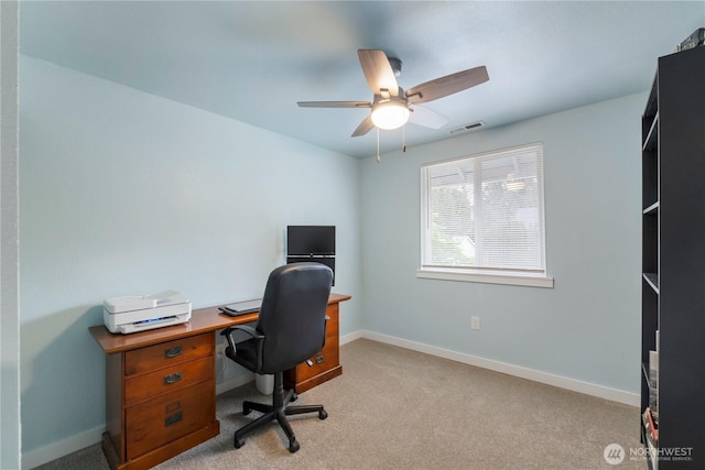 office space with ceiling fan, baseboards, and light carpet