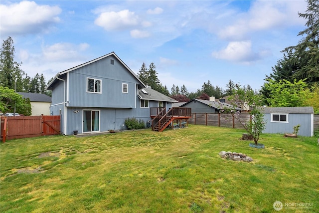 rear view of property with a deck, stairs, a gate, and an outdoor structure