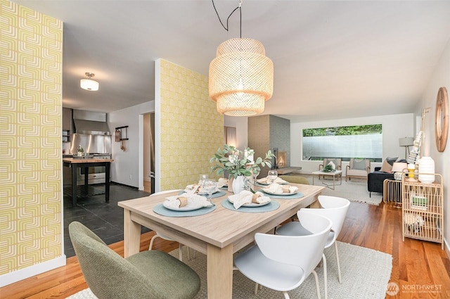 dining room featuring baseboards and wood finished floors