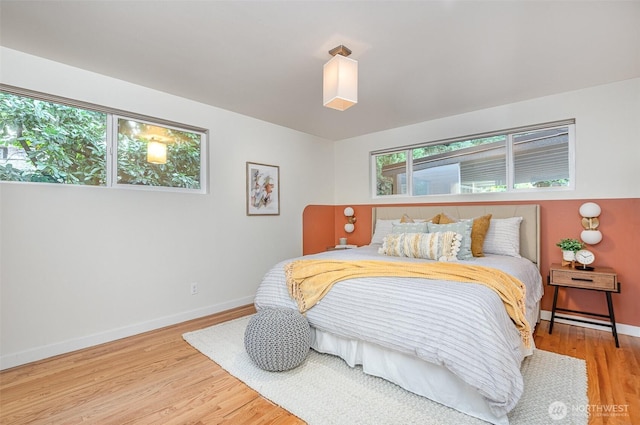 bedroom featuring baseboards and wood finished floors