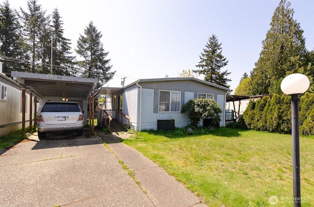 view of front of home with driveway, a front yard, and a carport