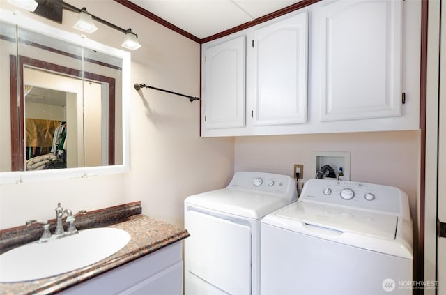 laundry room featuring independent washer and dryer, a sink, laundry area, and crown molding