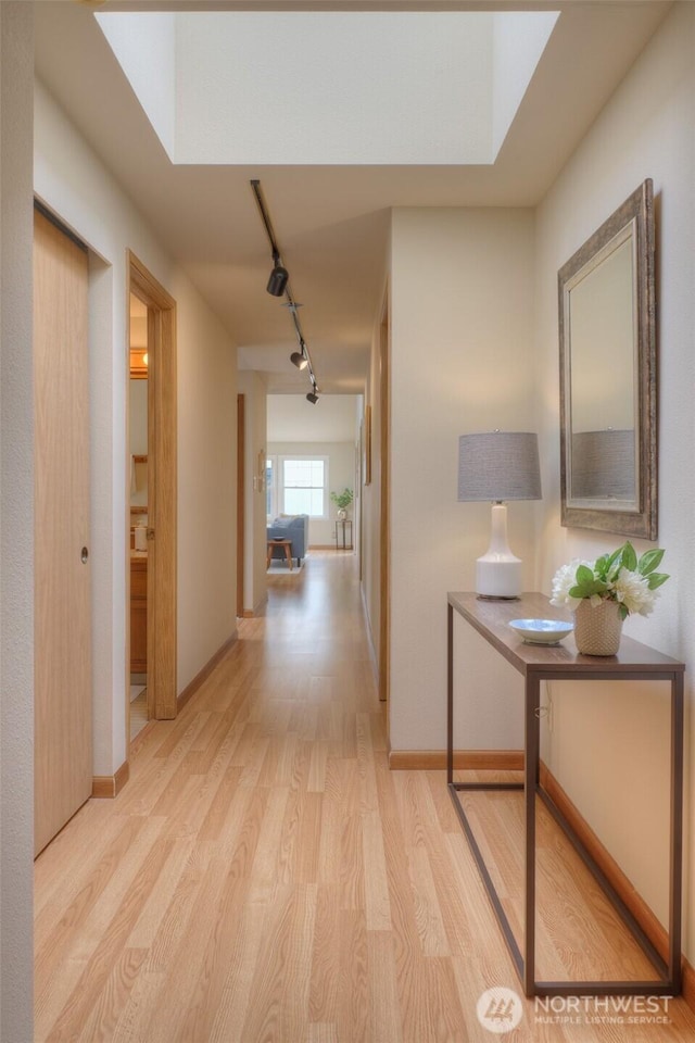 909 N 35th St Unit 402, Seattle, WA 98103 - hall featuring track lighting, baseboards, and light wood-type flooring