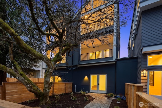 13546 39th Ave NE Unit B, Seattle, WA 98125 - rear view of property with stucco siding, fence, and french doors