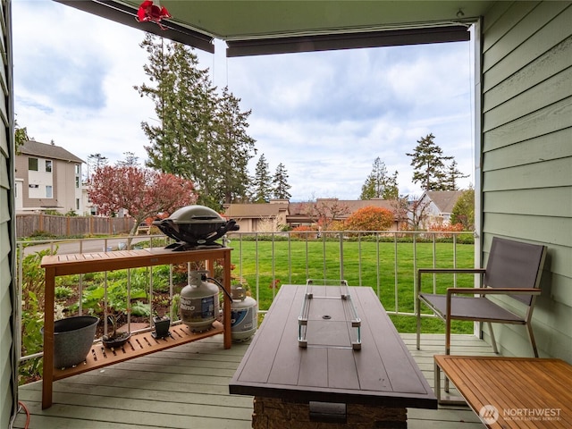 deck featuring a fenced backyard, a yard, and outdoor dining space