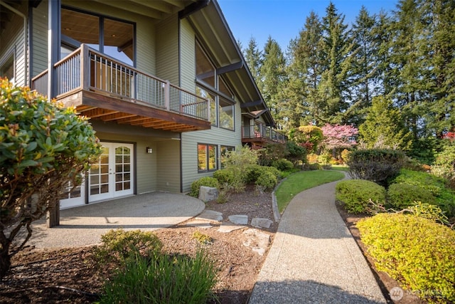 exterior space with a patio, french doors, and a balcony