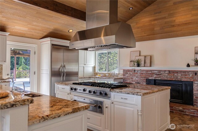 kitchen featuring wood ceiling, stainless steel appliances, a warming drawer, wall chimney range hood, and vaulted ceiling