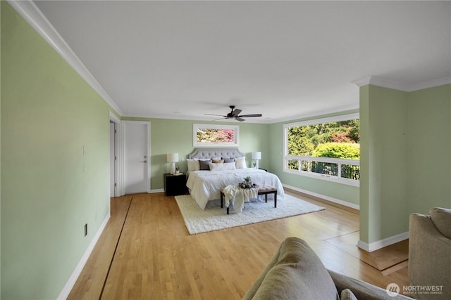 bedroom featuring baseboards, light wood-type flooring, ornamental molding, and a ceiling fan