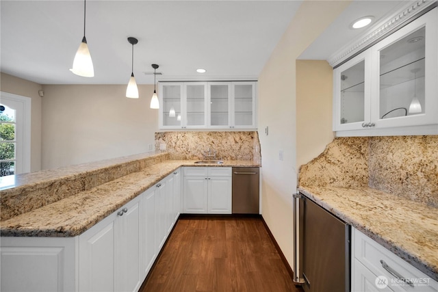 kitchen with decorative backsplash, white cabinets, dark wood-style floors, light stone countertops, and recessed lighting