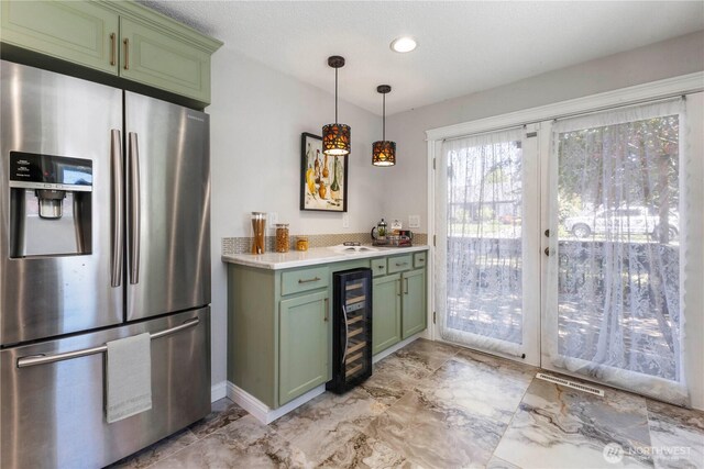 indoor dry bar with stainless steel refrigerator with ice dispenser, wine cooler, light marble finish flooring, and decorative light fixtures