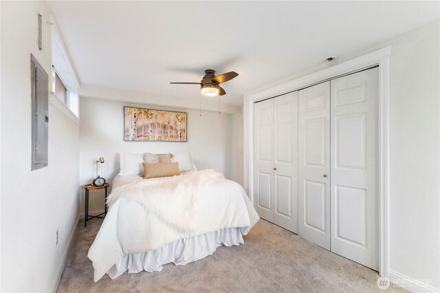 bedroom featuring carpet flooring, a closet, a ceiling fan, and electric panel