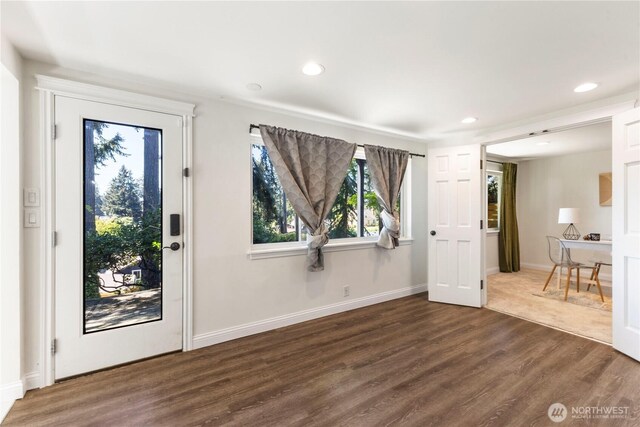 foyer entrance with wood finished floors, recessed lighting, and baseboards