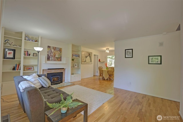 381 Fir Acres Dr NW, Bainbridge Island, WA 98110 - living room with crown molding, light wood finished floors, visible vents, and baseboards