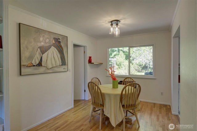 381 Fir Acres Dr NW, Bainbridge Island, WA 98110 - dining space featuring baseboards, ornamental molding, and light wood-style floors