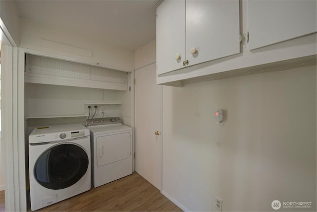 381 Fir Acres Dr NW, Bainbridge Island, WA 98110 - laundry area with light wood-type flooring, cabinet space, and washer and clothes dryer