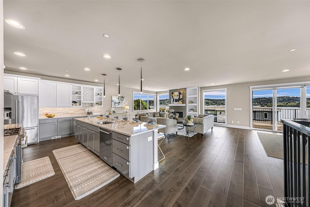 4888 194th Ave SE, Issaquah, WA 98027 - kitchen featuring open shelves, open floor plan, a kitchen island with sink, and dark wood-style flooring