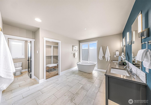 4888 194th Ave SE, Issaquah, WA 98027 - bathroom featuring a freestanding bath, wood finish floors, vanity, and recessed lighting