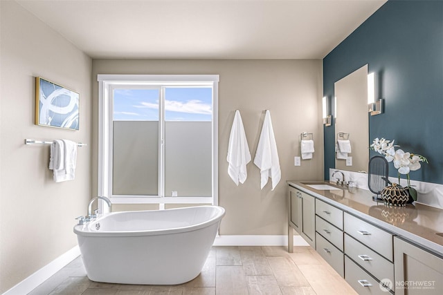4888 194th Ave SE, Issaquah, WA 98027 - bathroom featuring baseboards, a freestanding tub, and vanity