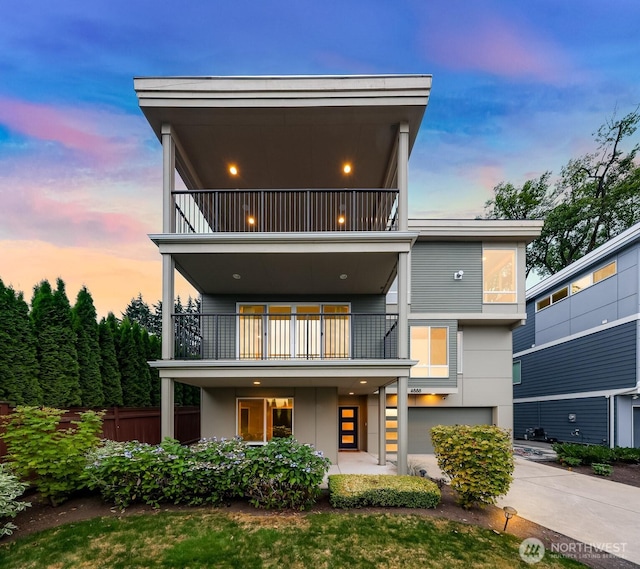 4888 194th Ave SE, Issaquah, WA 98027 - view of front of property featuring fence, a balcony, a garage, and concrete driveway