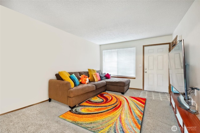 carpeted living area featuring a textured ceiling and baseboards