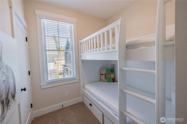 carpeted bedroom with baseboards and multiple windows