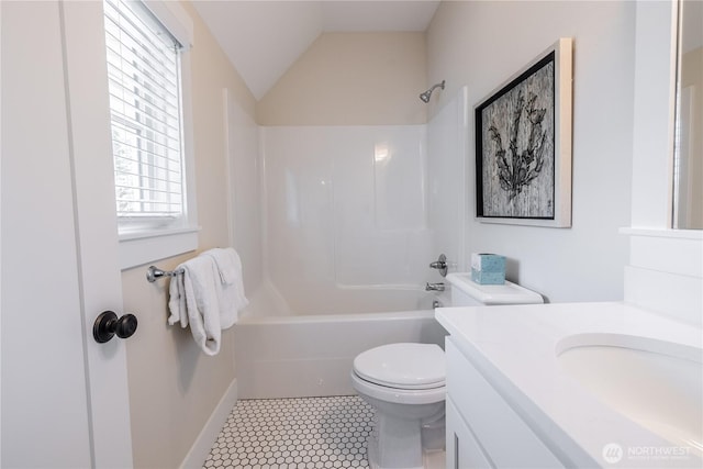 bathroom with washtub / shower combination, vaulted ceiling, toilet, and vanity