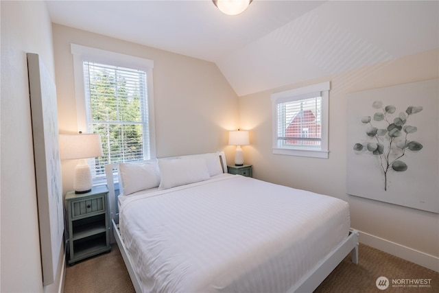 carpeted bedroom featuring vaulted ceiling, multiple windows, and baseboards