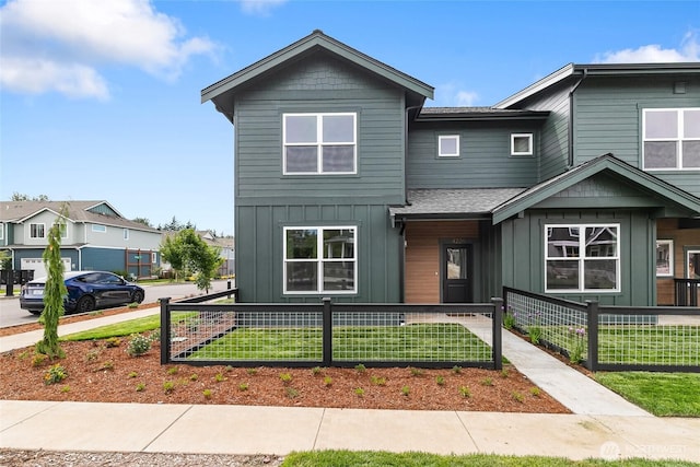 4226 Melrose Ln, Bellingham, WA 98226 - view of property with board and batten siding, a fenced front yard, and a shingled roof