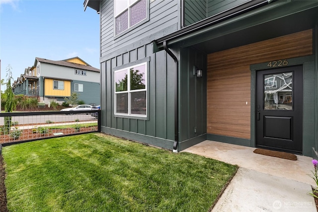 4226 Melrose Ln, Bellingham, WA 98226 - doorway to property with board and batten siding and a lawn