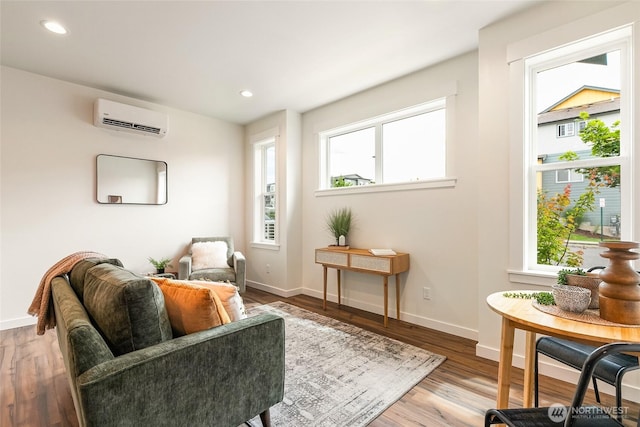 4226 Melrose Ln, Bellingham, WA 98226 - living area featuring an AC wall unit, plenty of natural light, wood finished floors, and recessed lighting