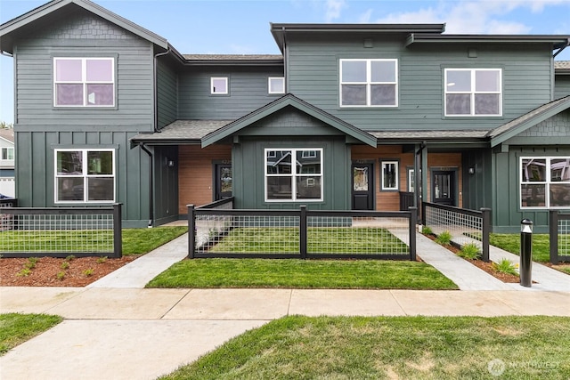 4228 Melrose Ln, Bellingham, WA 98226 - view of property with board and batten siding, a fenced front yard, a shingled roof, and a porch