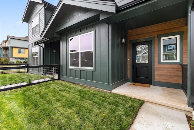 4228 Melrose Ln, Bellingham, WA 98226 - doorway to property featuring board and batten siding, a lawn, and covered porch