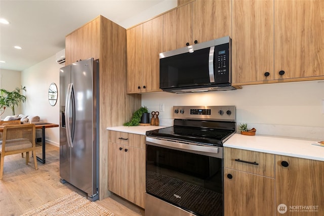 4228 Melrose Ln, Bellingham, WA 98226 - kitchen with stainless steel appliances, light wood-style floors, light countertops, recessed lighting, and an AC wall unit