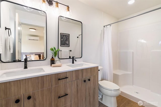 4228 Melrose Ln, Bellingham, WA 98226 - full bathroom with a wall mounted AC, double vanity, wood finished floors, and a shower with shower curtain