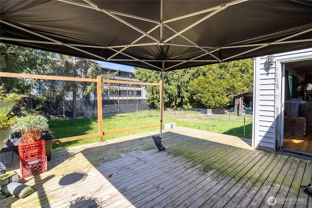 deck with a fenced backyard and a yard