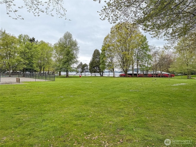 view of home's community featuring fence and a lawn