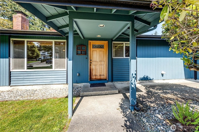 doorway to property with a chimney