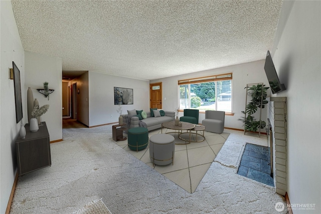 living room with carpet floors, baseboards, and a textured ceiling
