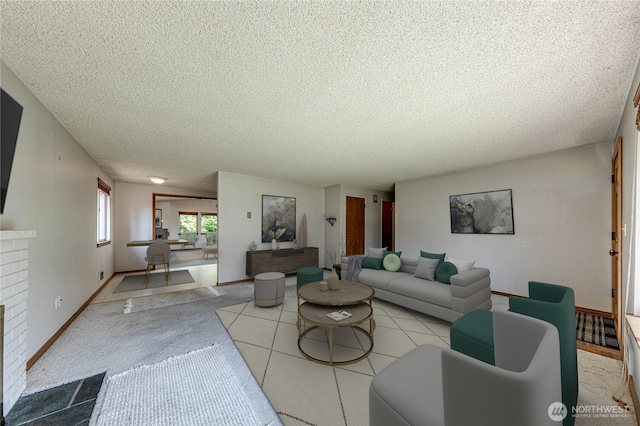 living area with a textured ceiling and a brick fireplace