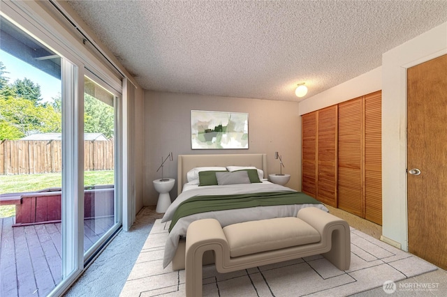bedroom with a textured ceiling and a closet