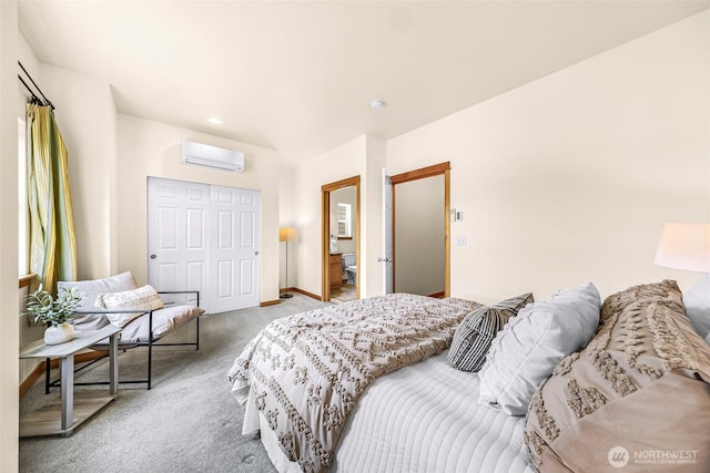 bedroom with a wall mounted AC, light colored carpet, a closet, and baseboards