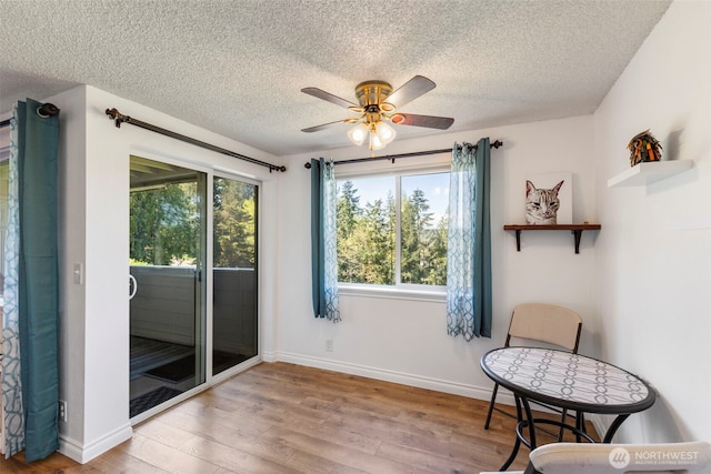 20145 Vikings Crest Loop NE Unit 3-105, Poulsbo, WA 98370 - living area with a textured ceiling, wood finished floors, and a healthy amount of sunlight