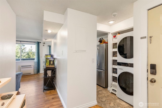20145 Vikings Crest Loop NE Unit 3-105, Poulsbo, WA 98370 - washroom with baseboards, stacked washer and dryer, and laundry area