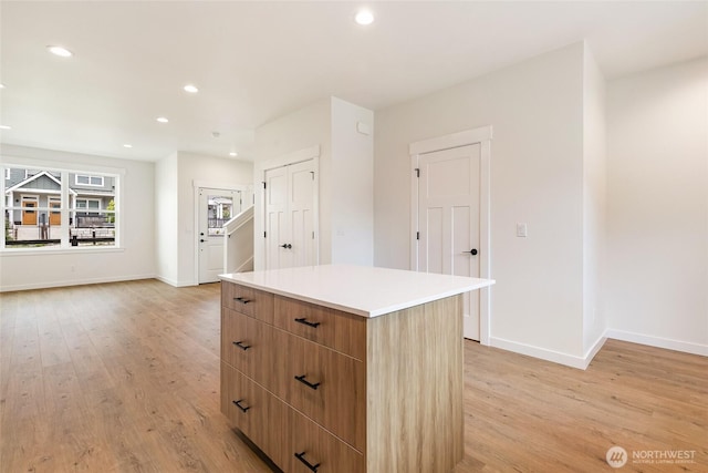 4230 Melrose Ln, Bellingham, WA 98226 - kitchen with a center island, light wood-style flooring, recessed lighting, light countertops, and modern cabinets