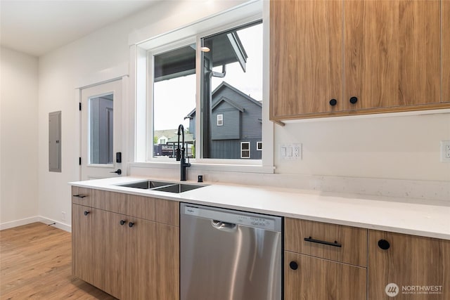4230 Melrose Ln, Bellingham, WA 98226 - kitchen with stainless steel dishwasher, electric panel, light wood-type flooring, light countertops, and brown cabinets