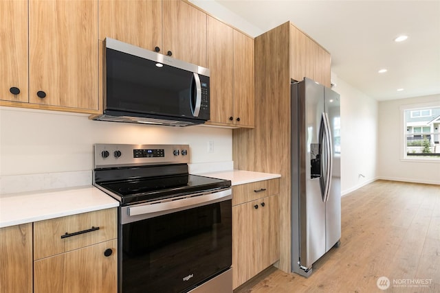 4230 Melrose Ln, Bellingham, WA 98226 - kitchen featuring appliances with stainless steel finishes, light wood-style floors, light countertops, modern cabinets, and recessed lighting