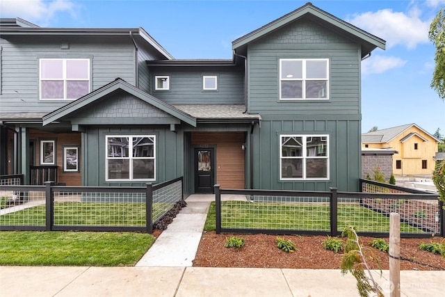4232 Melrose Ln, Bellingham, WA 98226 - view of front of property with board and batten siding, a fenced front yard, and a shingled roof